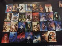 A collection of 30 fantasy-themed collectible cards with detailed and colorful artwork arranged on a surface.