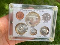 Front view of six Canadian coins in plastic case showing reverse designs with animals and denomination details.