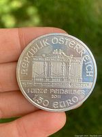 Front side of the Austrian 1oz silver coin showing the architectural design with denomination and year.