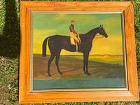 Frontal view of the framed hand painted horse and jockey painting showing the subject, signature, and visible condition.