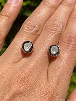 Front view of both earrings showing irregular rose-cut diamonds bezel-set with blue enamel border