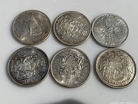Obverse and reverse sides of six Canadian silver half dollar coins featuring different years and designs including polar bear and Canadian coat of arms.
