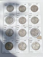 Obverse views of 12 Walking Liberty half dollars in labeled flips showing dates and mint marks