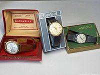 Three vintage wristwatches in original branded boxes: Caravelle, Cardinal, Westclox.