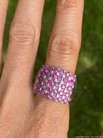 Ring worn on finger showing the square grid pattern of genuine rubies set in real silver band