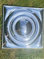 Front view of reflective concentric rings mounted on grass surface