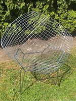 Front view of chrome wire mesh bucket chair showing seat and backrest