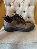 Side view of one brown nubuck Clarks waterproof shoe showing black rubber sole and toe cap, laces, and stitching details.