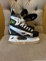 Side view of one skate showing design, branding and blade holder.