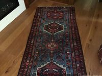 Full length view of the runner laid on hardwood floor