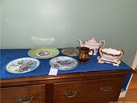 Full view of the lot showing all seven pieces arranged on a table with blue cloth.