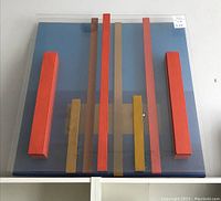 Front view of artwork showing geometric colored blocks on blue background