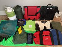 Full assortment of camping supplies including bags, dry bag, thermos, and clothing.