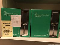 Three green boxes each labeled 12x Champagne/Flute/Sekt 17cl-6oz with 'Bouquet Leerdam' branding. One box is noted as missing one glass, total 35 glasses.