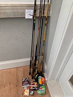Full view of seven rods leaning against wall with lines and spool on floor