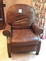 Front-facing view of brown leather recliner chair