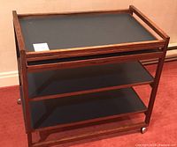 Front view of bar cart showing top shelf and two lower shelves