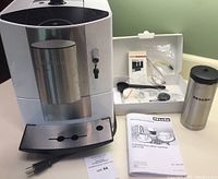 Front view showing machine and accessories on countertop