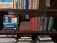 Bookshelves with a variety of vintage and old books, including some Shakespeare titles and historical memoirs.