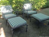 Front view of two metal outdoor chairs with striped cushions, two ottomans and round side table