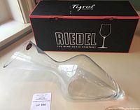 Decanter displayed next to original black and red Riedel box