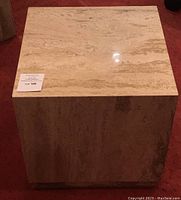 Top view of cube table showing polished top surface and travertine veining