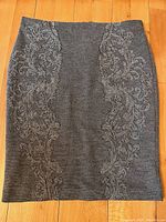 Front view of grey wool blend skirt showing floral jacquard side patterns