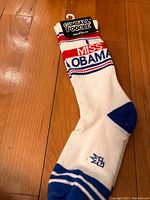 Front view of one Gumball Poodle white crew sock with 'I Miss Obama' text and blue toe and heel