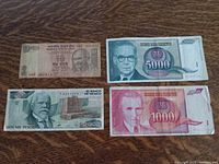 Photo showing Indian 10 Rupees bill with Gandhi, Yugoslavian 5000 and 4000 dinars, Mexican 2000 Pesos, and Yugoslavian 1000 dinars in circulation condition.