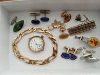 Tray with pocket watch, watch chain, multiple pairs of cufflinks and tie bar
