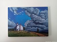 Front view of original church yard scene canvas painting showing the subject: white church on hill with dramatic cloudy sky.