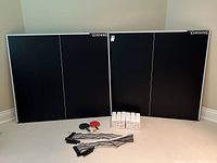 Overview of both table top halves, net, paddles, balls and boxes