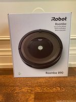 Front of sealed retail box showing iRobot Roomba logo and image of the Roomba 890