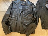 Front view of black Belstaff leather biker jacket with asymmetrical zip front and multiple zip pockets