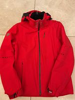 Full front view of red Descente jacket on hanger