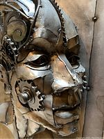 Close-up view of face showing welded steel sheets, sprockets and chain details