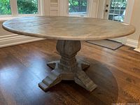 Front three-quarter view of entire table showing tabletop and pedestal base