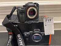 Camera body mounted on original box, front view showing mount and sensor