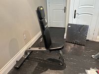 Bench in upright incline position with floor mats in background