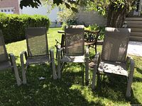 Three chairs viewed from front under tree