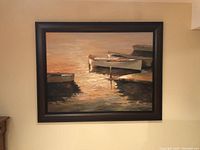 Front view of the framed painting depicting boats at sunset in calm waters with warm tones.