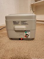 Front view showing control dial, temperature control markings, and brand label.