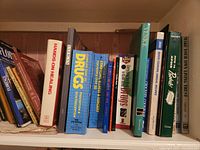 Shelf of books including Hands-On Healing, books on drugs, surgery, art, quick cooking, and Bible topics.