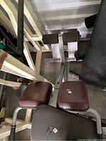 Top view of the padded seat and leg roller supports with diamond plate footrests on the Promaxima back extension bench.