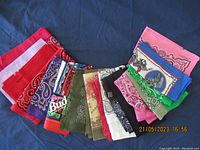 Overall spread of bandanas showing the array of colors and patterns including traditional paisley and graphic prints.