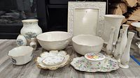 Full set of 19 Lenox porcelain items including bowls, vases, music box, and picture frame arranged on floor