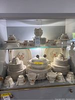 Full view of top and bottom shelves showing complete Temple Blossom china set