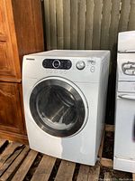 Front view of Samsung electric dryer showing door and control panel