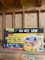 Boxed 7 inch tile wet saw by WorkForce, model HD550, showing front side with product features and images.