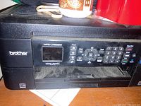 Front view of Brother MFC-J480DW printer showing brand name, model number, control panel with numerous buttons and display screen.